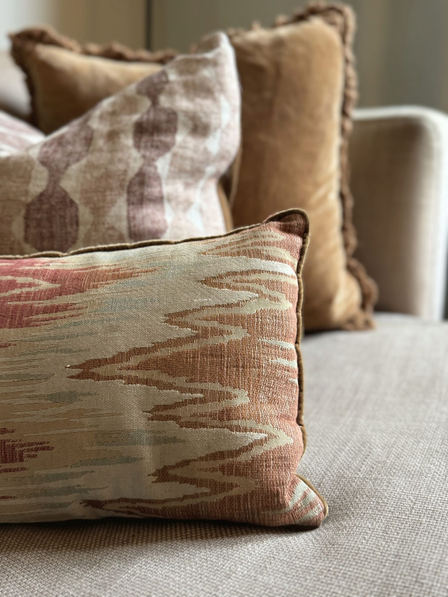 Layered cushions in ikat and velvet