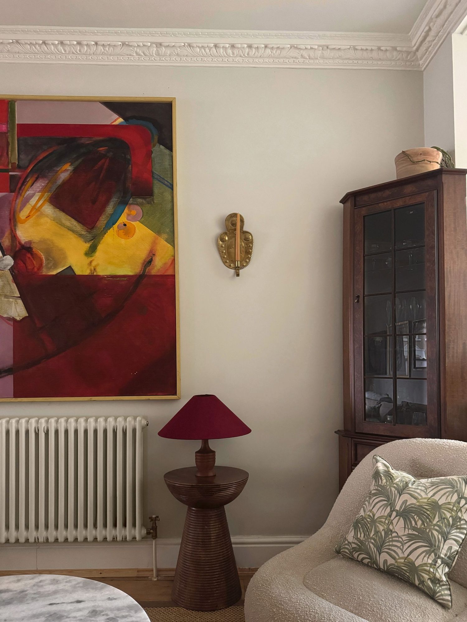 Whitney Road living room with abstract painting, burgundy lamp and boucle chair